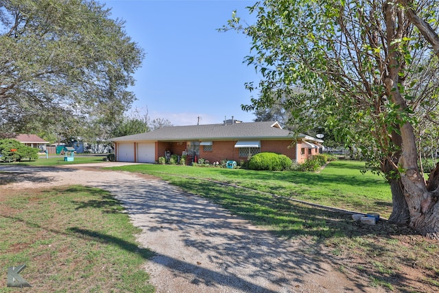 ranch-style house featuring a front lawn and a garage