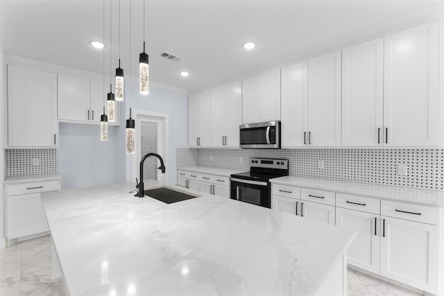 kitchen featuring light stone counters, stainless steel appliances, sink, and white cabinets