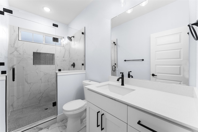 bathroom with a shower with door, vanity, and toilet