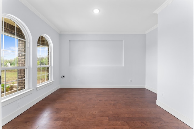 empty room featuring crown molding and dark hardwood / wood-style flooring