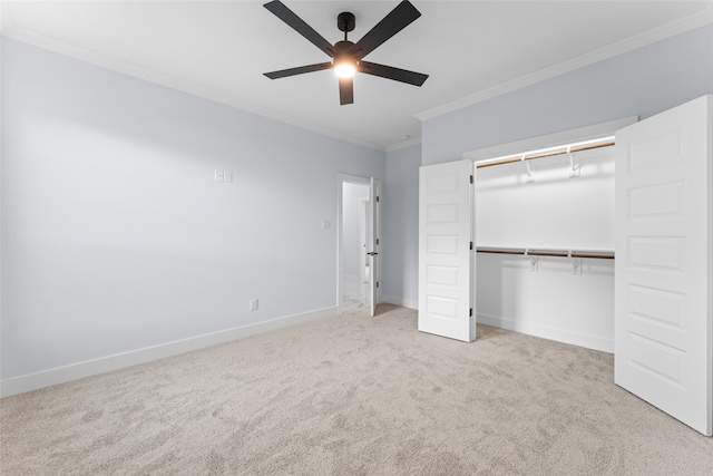 unfurnished bedroom with crown molding, ceiling fan, light carpet, and a closet