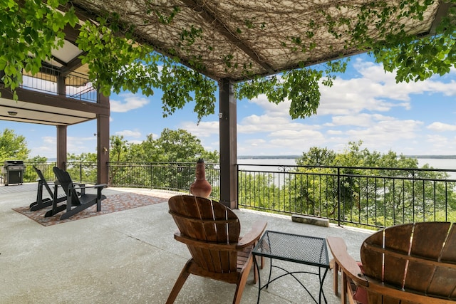 view of patio / terrace with a balcony, a water view, and a grill