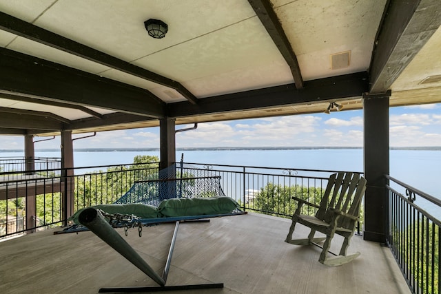 view of patio with a balcony and a water view