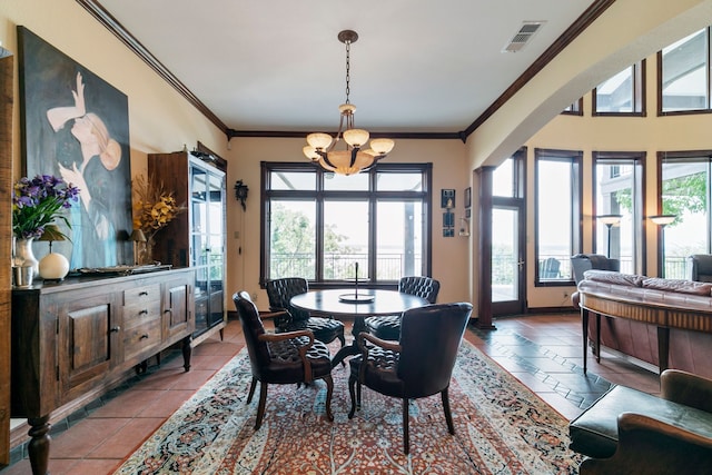 dining space featuring a wealth of natural light, ornamental molding, a chandelier, and light tile patterned flooring