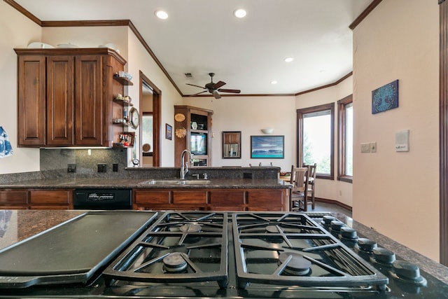 kitchen featuring backsplash, dishwasher, sink, ceiling fan, and ornamental molding