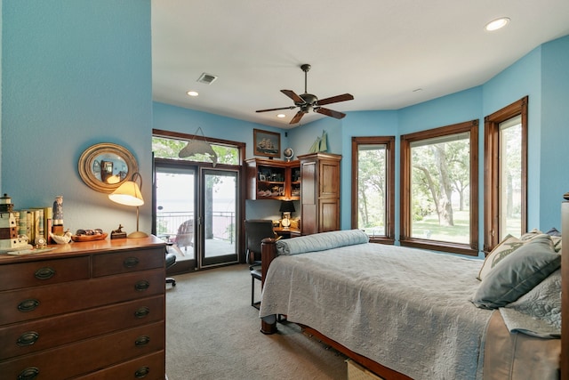 carpeted bedroom with ceiling fan, multiple windows, and access to outside