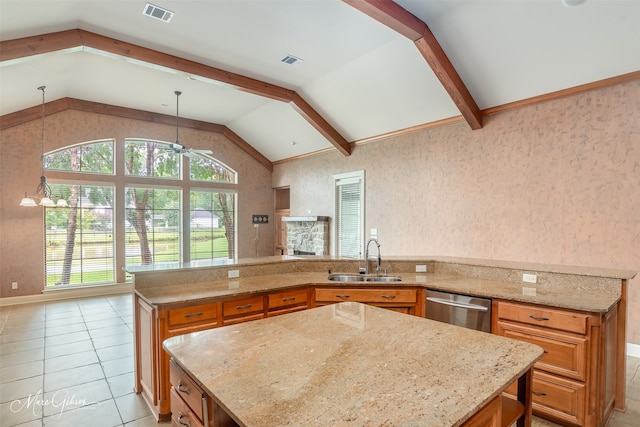 kitchen featuring light stone countertops, pendant lighting, stainless steel dishwasher, sink, and vaulted ceiling with beams