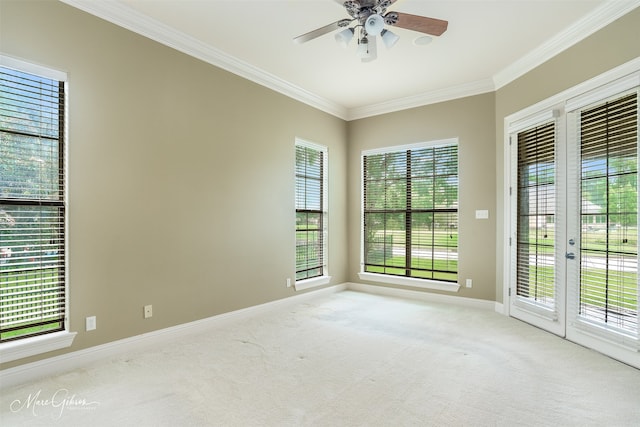 empty room featuring crown molding, a healthy amount of sunlight, and ceiling fan