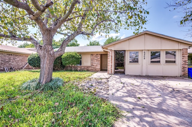 single story home with a patio and a front lawn