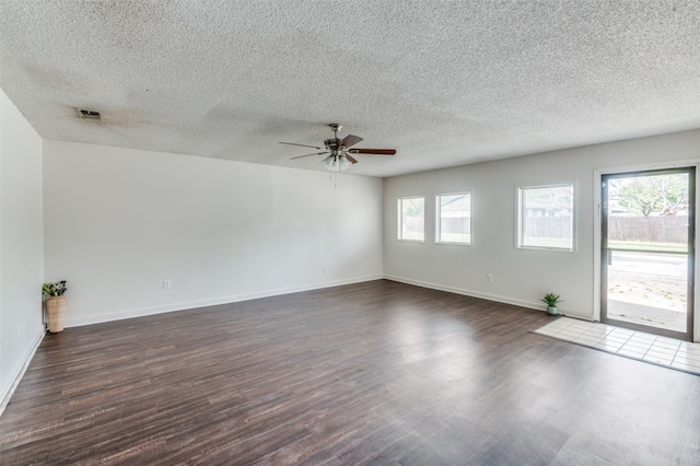 spare room featuring a textured ceiling, ceiling fan, and dark hardwood / wood-style flooring