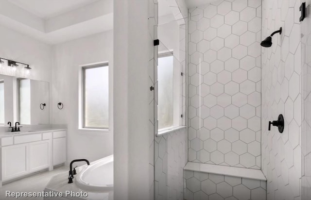 bathroom featuring a tile shower, a bath, and vanity