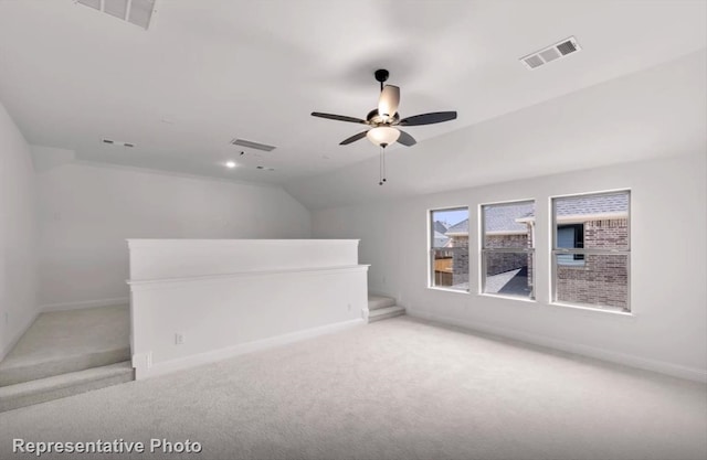 unfurnished room featuring lofted ceiling, visible vents, and baseboards