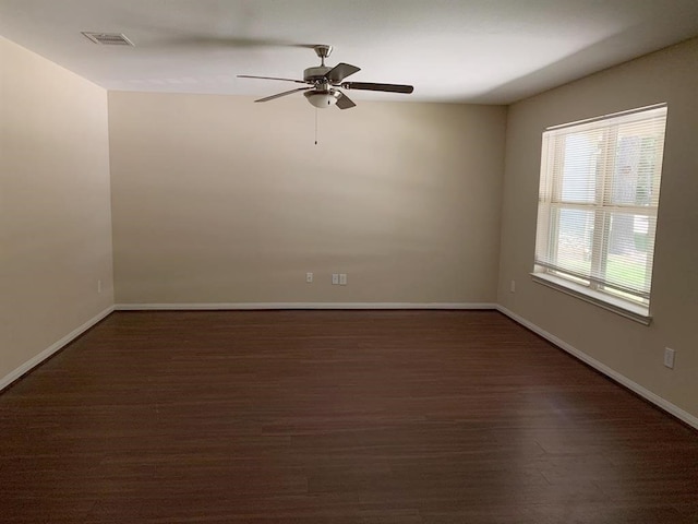 unfurnished room with ceiling fan and dark hardwood / wood-style floors