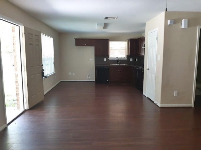 kitchen with dark hardwood / wood-style flooring, sink, and dark brown cabinetry