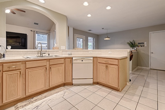 kitchen with dishwasher, light tile patterned floors, hanging light fixtures, sink, and light brown cabinets