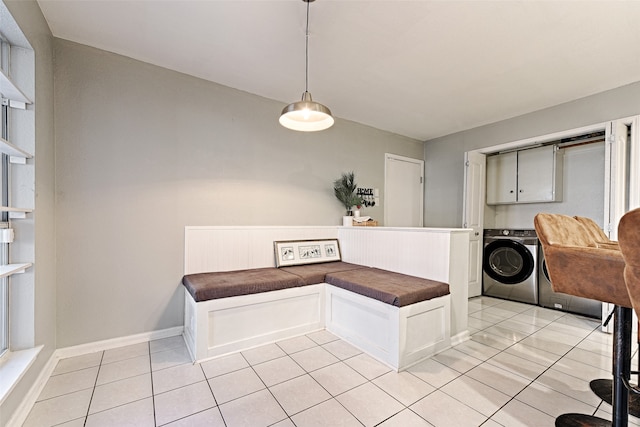 dining area with washer and dryer and light tile patterned flooring