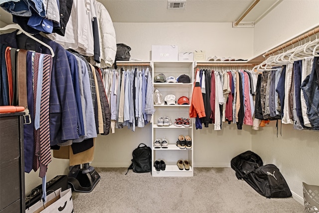 walk in closet with carpet