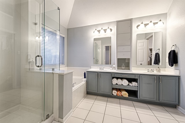 bathroom with lofted ceiling, tile patterned flooring, shower with separate bathtub, and vanity