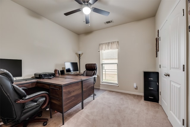 carpeted office space featuring ceiling fan