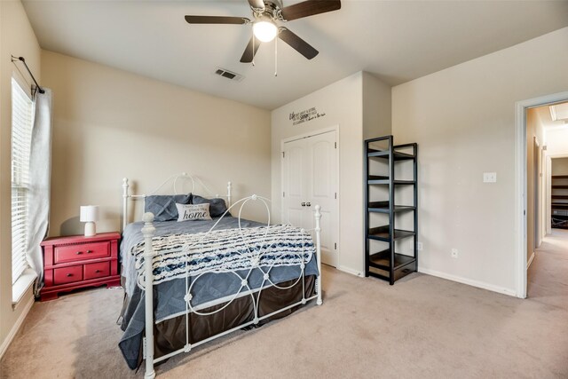 bedroom featuring a closet, ceiling fan, and carpet flooring