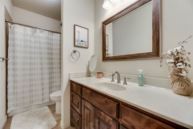 bathroom with vanity, toilet, and walk in shower