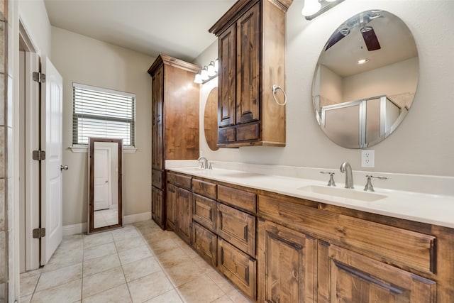 bathroom featuring tile patterned floors, a shower with shower door, ceiling fan, and vanity