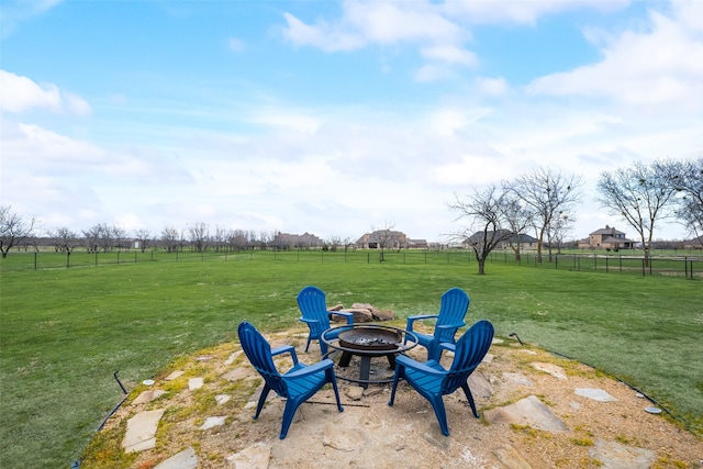 view of yard featuring a fire pit, a rural view, and a patio