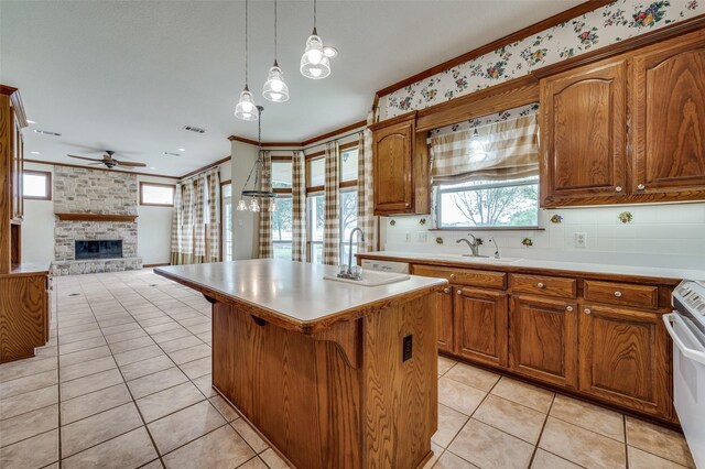 10200 Zipper Rd, Pilot Point, TX 76258 - kitchen featuring a ceiling fan, a fireplace, light tile patterned floors, light countertops, and open floor plan
