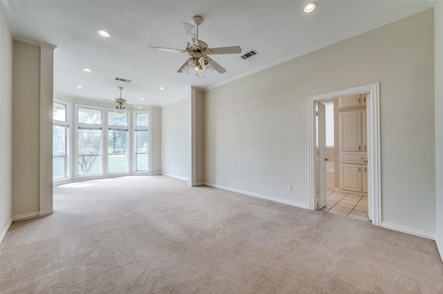 carpeted empty room featuring crown molding and ceiling fan