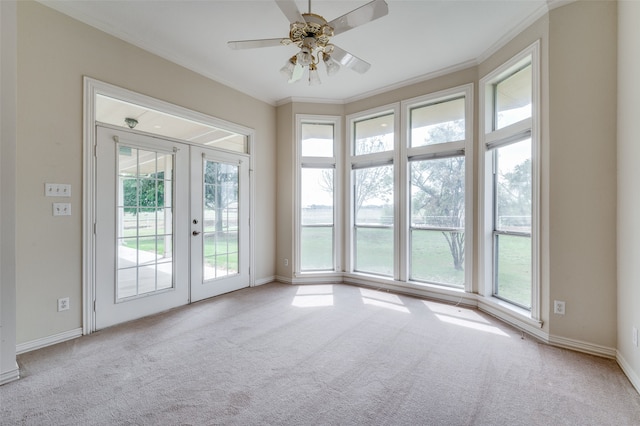 unfurnished room featuring ceiling fan, light carpet, and ornamental molding