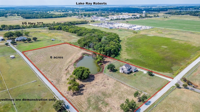 birds eye view of property with a water view and a rural view