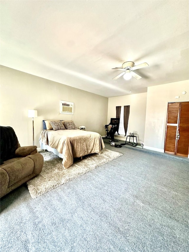 carpeted bedroom featuring ceiling fan and a wall mounted air conditioner