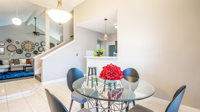 tiled dining space featuring ceiling fan and lofted ceiling with beams