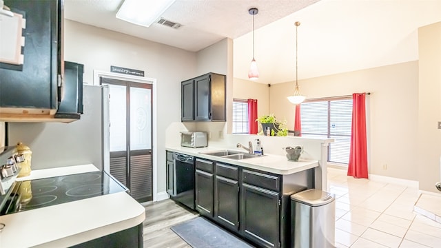 kitchen featuring decorative light fixtures, dishwasher, kitchen peninsula, sink, and stainless steel range with electric stovetop