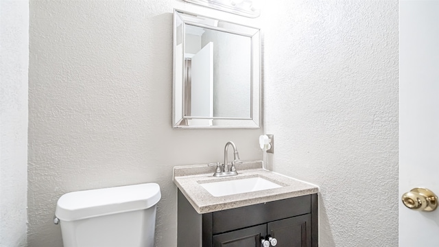 bathroom with toilet and vanity