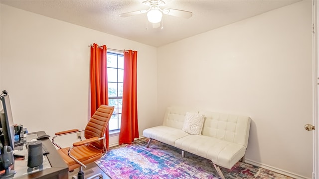 office space with ceiling fan and a textured ceiling