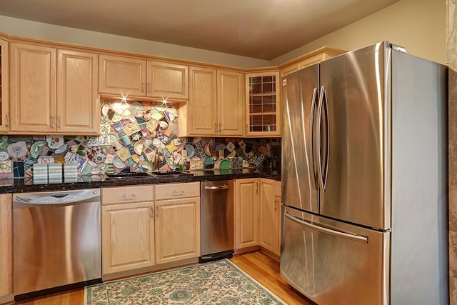 kitchen with light wood-type flooring, appliances with stainless steel finishes, and light brown cabinetry