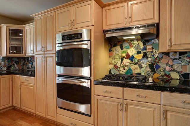 kitchen featuring light brown cabinets, double oven, and light hardwood / wood-style floors