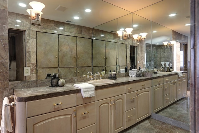 bathroom featuring vanity and tile walls