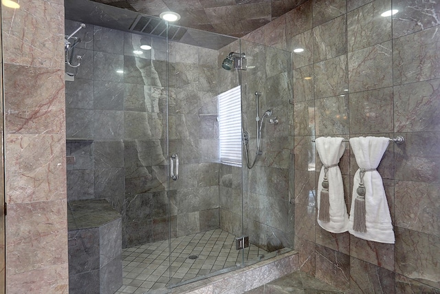 bathroom featuring a shower with door