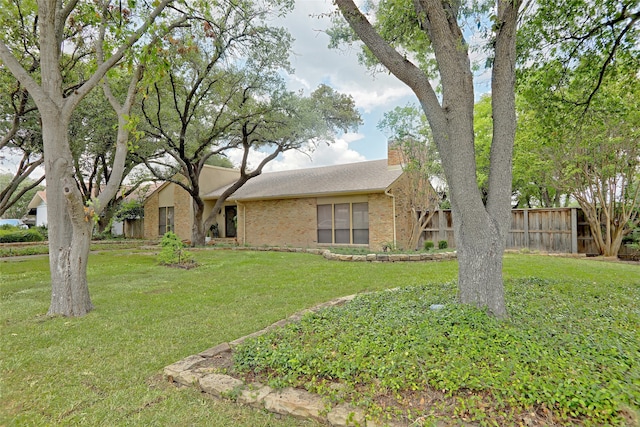 ranch-style home with a front yard