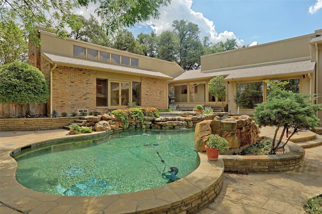 view of swimming pool with a patio