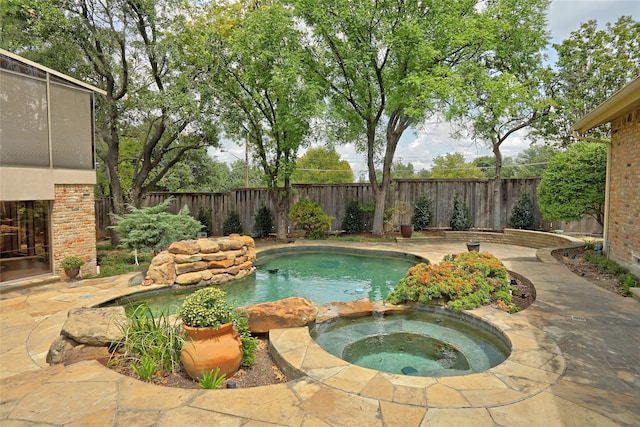 view of pool featuring a patio area and an in ground hot tub