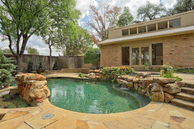 view of swimming pool with a patio area