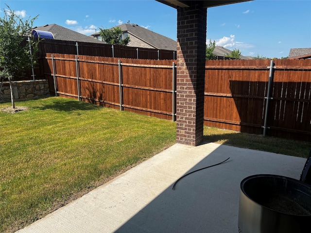 view of yard with fence and a patio