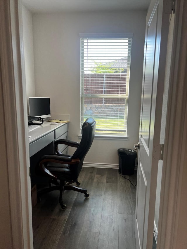 office space with wood finished floors, baseboards, and plenty of natural light