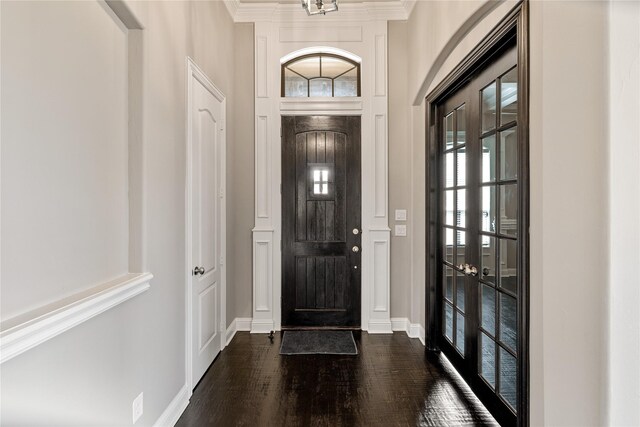 unfurnished room featuring ceiling fan, a raised ceiling, crown molding, and dark wood-type flooring