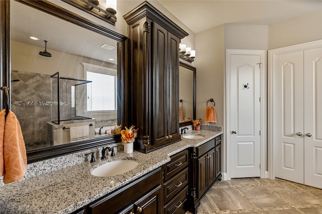 bathroom featuring vanity and tiled shower