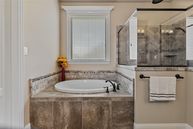 bathroom featuring independent shower and bath