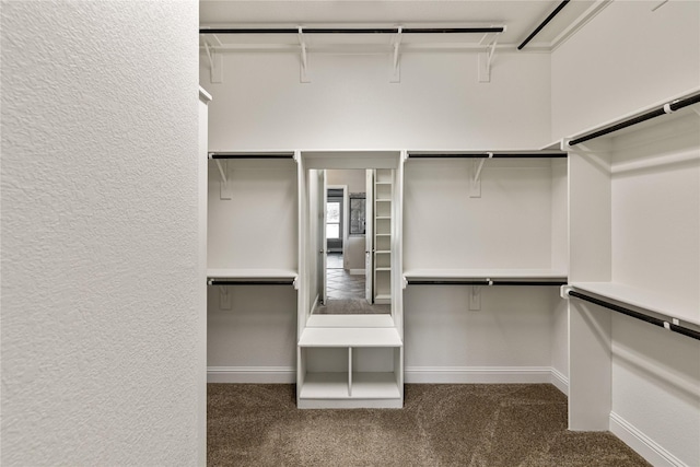 spacious closet featuring dark carpet